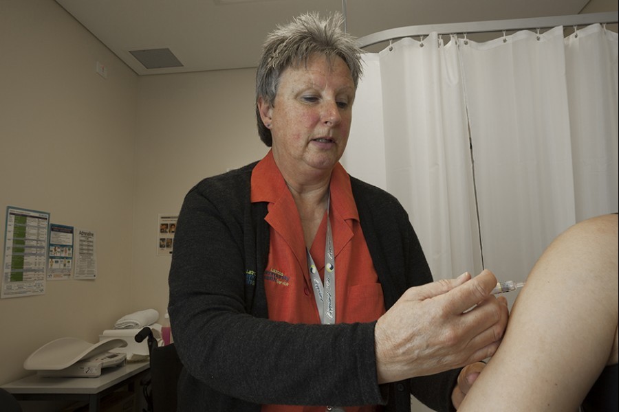 Nurse injecting patient's shoulder