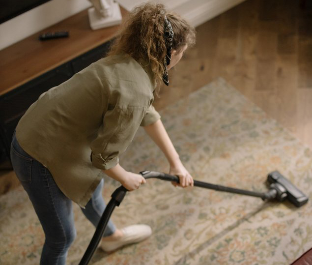 birds-eye view of a women vacuuming a rug